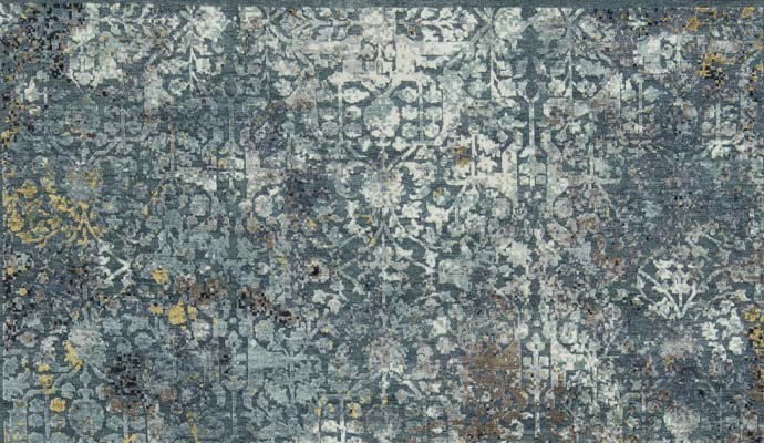 A blue rug has a distressed pattern.