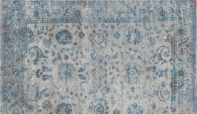 A gray rug has blue florals.