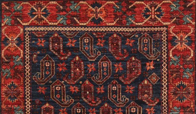 A navy rug has paisley motifs.