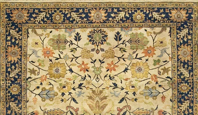 An ivory rug has floral vines.
