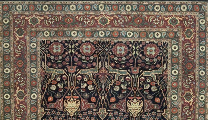 Bakshahesh collection transitional rug with navy field and intricate floral border