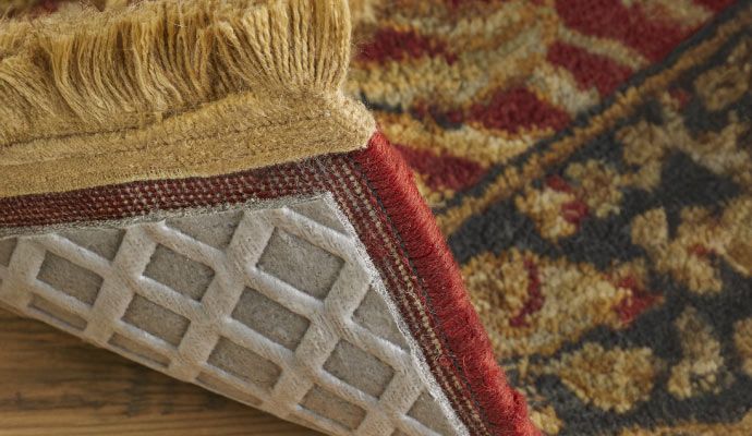 Non-slip rug pad placed under a rug to prevent sliding and protect the floor