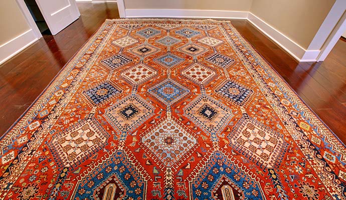 Orange geometric rug on a hardwood floor
