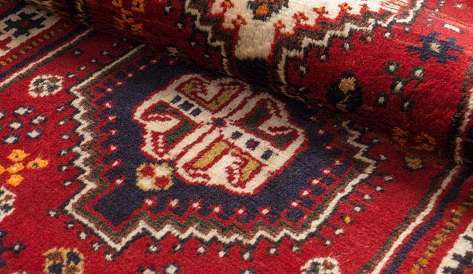Red oriental rug with geometric patterns