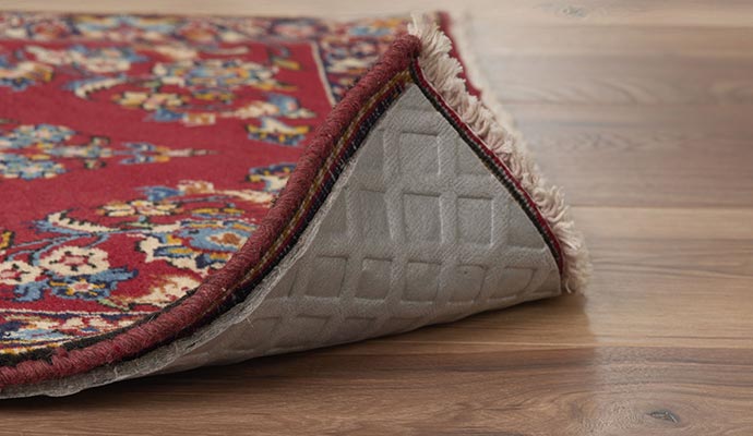 Rug with rug pad on a wooden floor