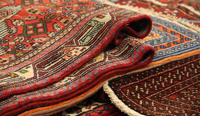 Stack of colorful oriental rugs