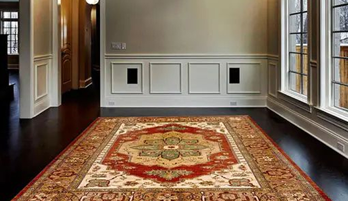 Traditional rug placed on a dark wooden floor